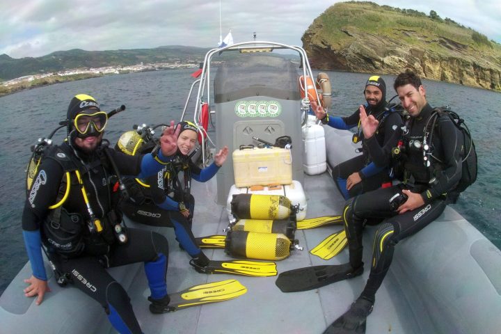 a group of people sitting on top of a mountain
