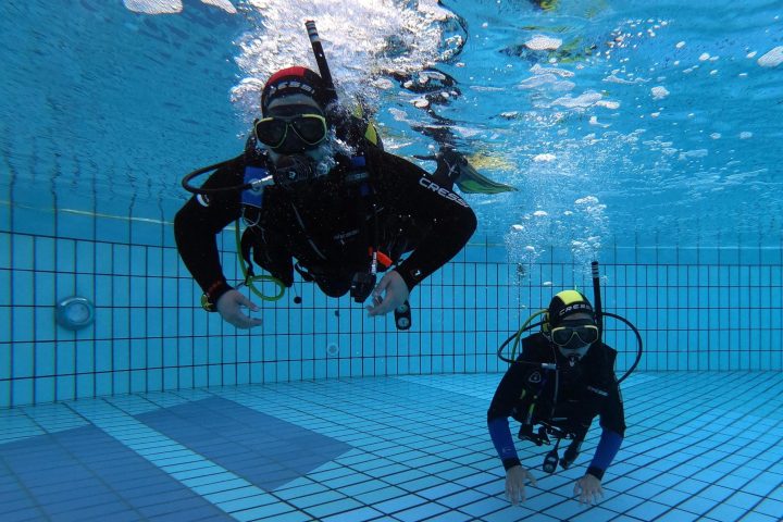a group of people riding skis across snow covered ground