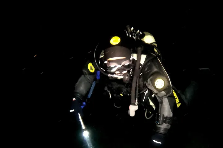 a person sitting in a dark room