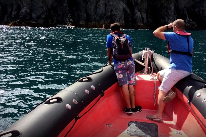 a person riding on the back of a boat in the water