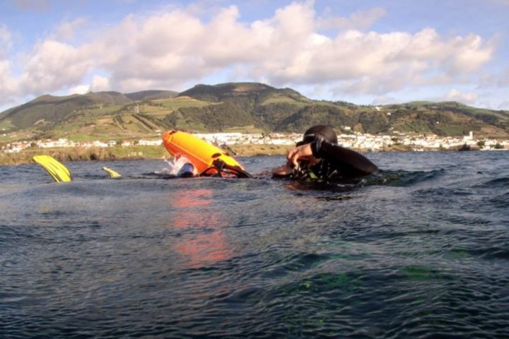 a group of people on a beach near a body of water