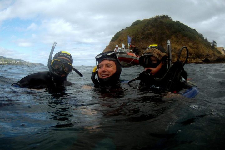 a man standing next to a body of water