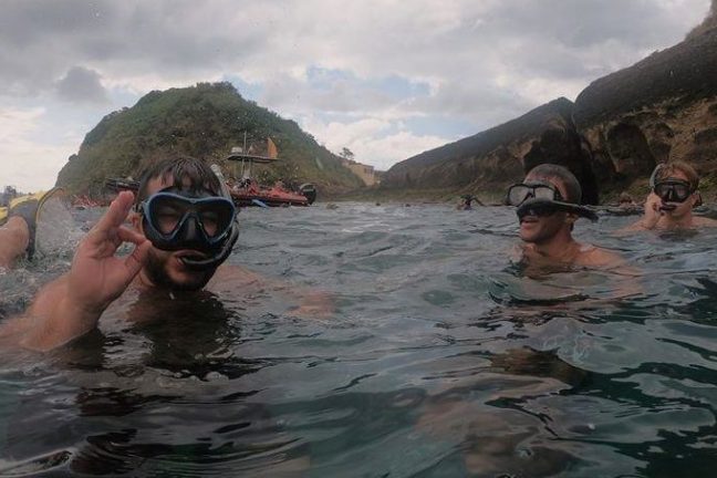 a group of people swimming in the water